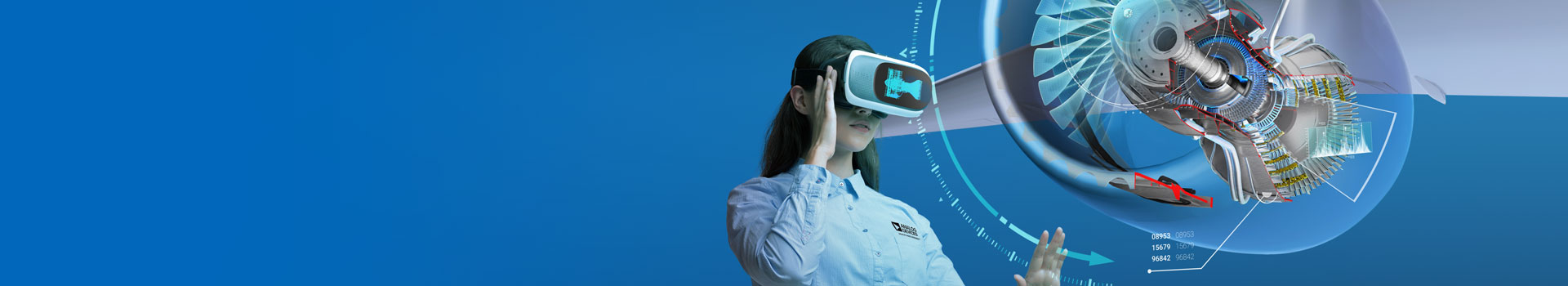 Young engineer uses virtual reality to rotate a turbine engine's digital twin.