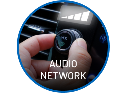 Hand adjusting car audio knob with 'Audio Network' overlay; dashboard visible.