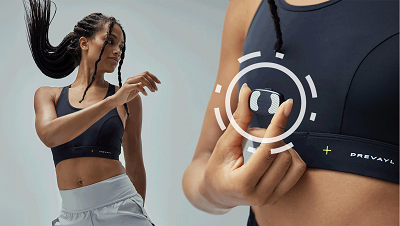 A woman in sports bra and shorts moving and holding Prevayl Sensor