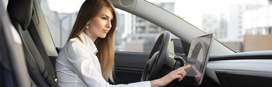 Businesswoman making adjustments in a self driving car