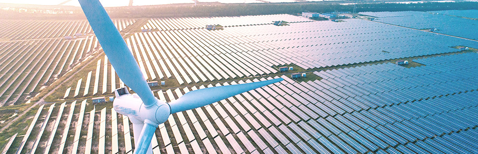Wind turbine and solar panels on the field