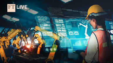 Woman in hard hat looking at a holographic diagnostics screen in front of industrial robots