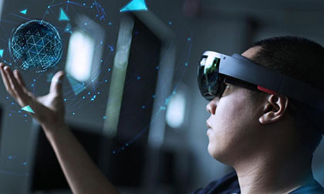 Man with HoloLens glasses holds a virtual reality ball