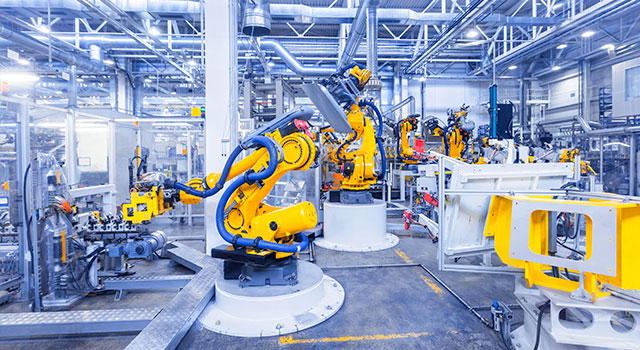 Mounted robotic arms in a factory.