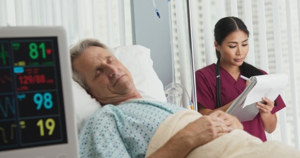 Figure 1. A nurse documenting the vital signs of a hospital patient.
