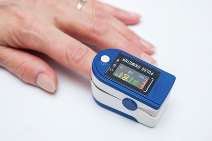 Figure 2. Finger-worn pulse oximeter measuring SpO2.