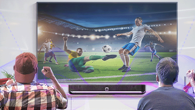 A group of 4 men partially immersed into a soccer game via the beosound soundbar providing realistic live sound 