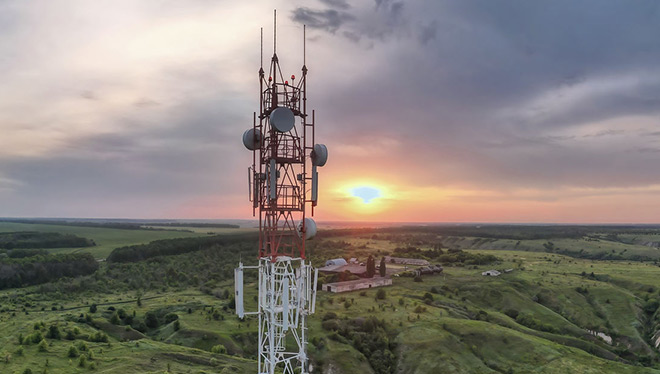 Panoramic view of telecommunications tower overlooking rural landscape at sunset